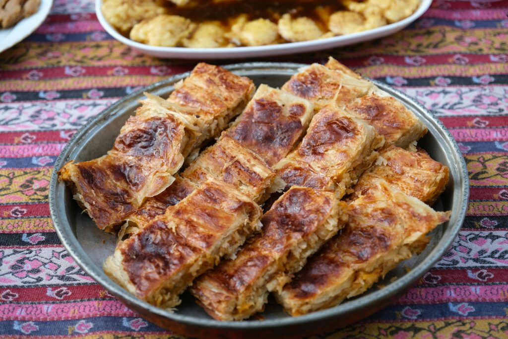 Delicious Turkish börek served on a decorative rug, showcasing Sivas culinary traditions.